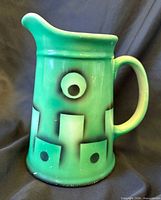 front view showing geometric design, spout, handle
