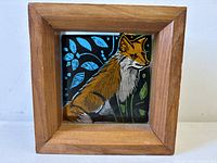 Front view of stained glass fox artwork in wooden frame