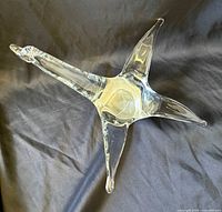 Top angled view of clear glass bird sculpture