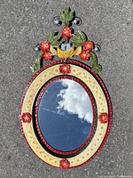 Full view of oval tin framed mirror front