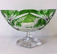 Front view showing elk engraving, green overlay, pedestal base