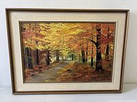 Front view of framed autumn landscape painting