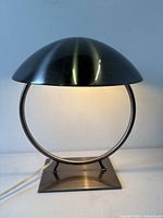Lamp lit showing brushed metal dome, ring frame and square base