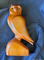 Front view of carved wood owl showing eyes and form