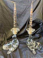 Full view of both sea-lion candlestick holders with candles inserted