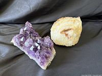 Amethyst cluster and quartz phantom on black fabric
