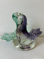 front view of fused purple and green glass birds sculpture
