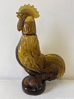 Full view left profile of amber glass rooster decanter