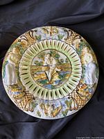 Front view showing entire charger with relief figures and pierced band