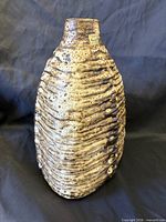 Front view of ribbed fat-lava vase with intact Carstens label