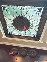 Square metal wall panel with scrollwork and cross medallion