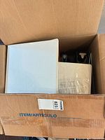 Top view of box showing white binder, other binders and folders