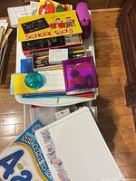 Top view of bin showing variety of school supplies, stickers, paper and storage boxes