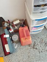 Overall lot with Sterilite drawers, toolbox, fuel can and box of tools