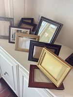 Group of assorted frames on shelf showing finishes and sizes