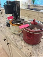 Group shot of coffee maker and two slow cookers on countertop