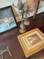 Group view: framed Daniel print, cherub statue, standing cross base, framed cherub print