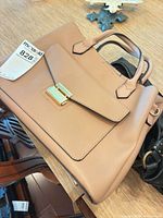 Blush structured satchel on table