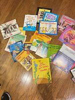 Top-down view of entire spread of children’s books on floor