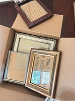 Four frames in box: gold scroll square, bronze bevel 5x7, silver narrow 5x7, small wood 4x6