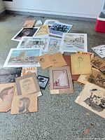 All artworks spread on floor showing variety of pieces and media