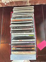 Full stack of CDs in open box showing spines