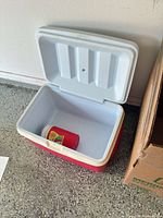 Cooler open showing interior and small jug inside