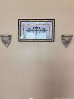 Full view of framed art flanked by both corbels mounted on wall
