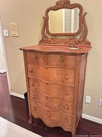 Front view of oak dresser showing six drawers and attached mirror