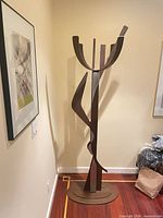 Full front view of bronze patina metal coat rack