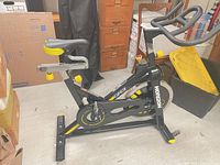 Full left-side view of Horizon GR3 spin bike showing frame, flywheel, pedals, resistance knob