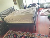 Full view of assembled king bed frame showing headboard, footboard, rails and espresso finish