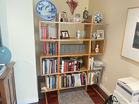 Front view of entire bookcase filled with books and decor