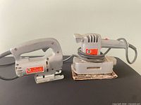 Front view of jigsaw and orbital sander showing overall condition