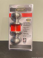 Front of packaged Defiant Hartford satin nickel keyed entry door knob showing brand and product details