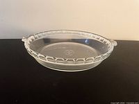 Oblique side view showing scalloped rim and handles