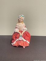 Front view of Royal Doulton Peggy HN2038 figurine showing dress, fan and facial details