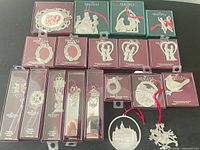 All 20 boxed ornaments laid out with two unboxed examples in foreground