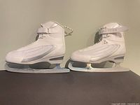 Left side view of both Softec white ice skates