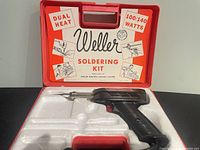 Closed carry case showing Weller branding and wattage info