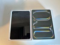 Front view of tablet beside retail box