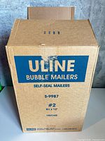 Closed Uline branded shipping carton showing model S-9987, size, and quantity information