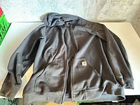 Front view of charcoal gray Carhartt full-zip hoodie laid flat