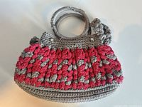 Front view of grey and pink crochet D&G handbag