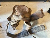 Top view of brown leather Western saddle showing horn, tooled seat and overall wear