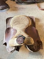 Top view of brown leather Western saddle with tan suede seat and horn
