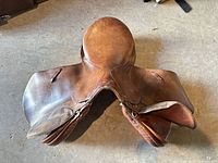 Top view of brown leather English saddle showing seat, flaps and overall wear