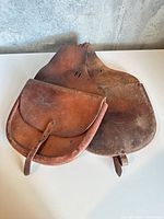 full view of both connected leather saddle bags showing overall wear