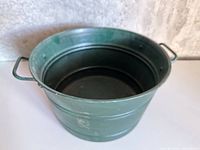 Top view of green metal tub showing interior and handles
