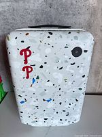 Front view showing terrazzo pattern, red P decals, top handle